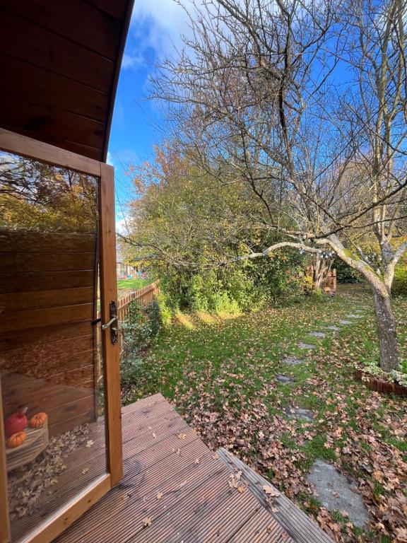 a sliding glass door to a yard with trees at La Parenthèse Enchantée in Rochefort