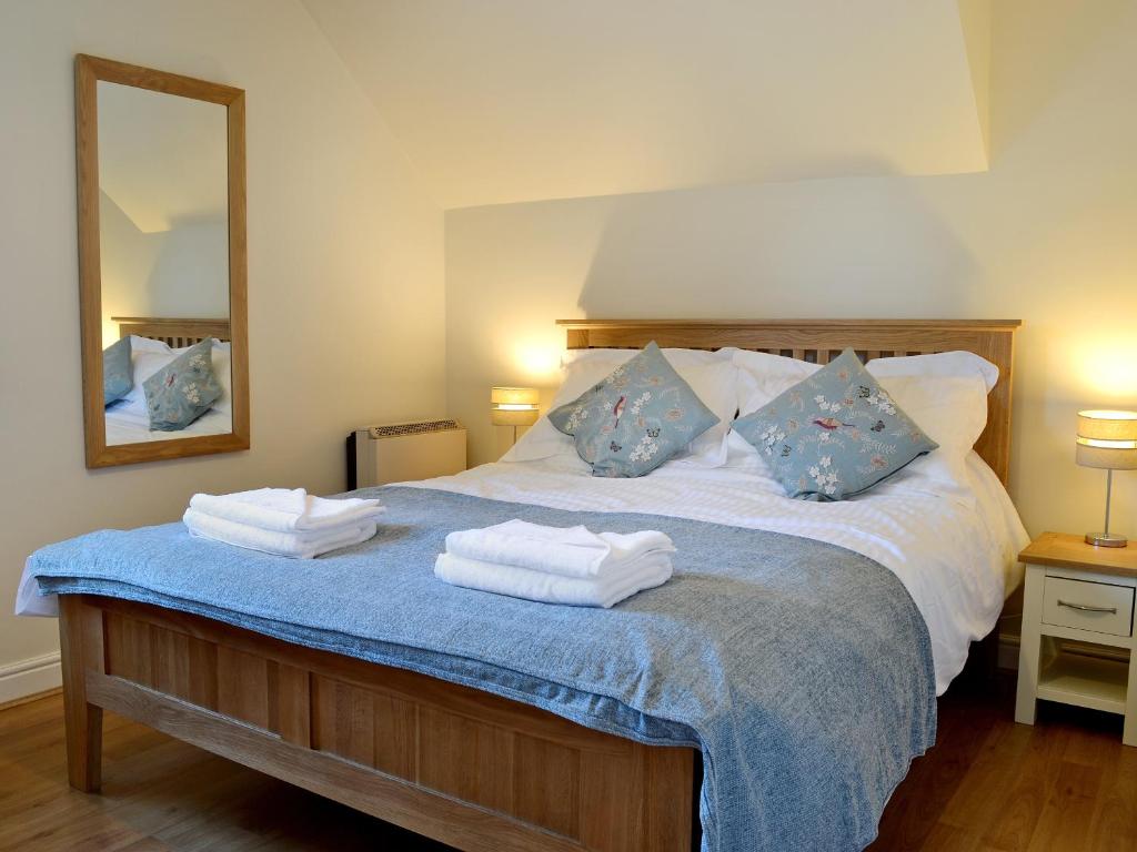 a bedroom with a bed with towels on it at Hindscarth in Keswick