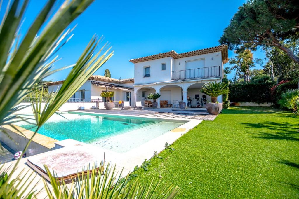 a villa with a swimming pool and a house at La Villa in Sainte-Maxime