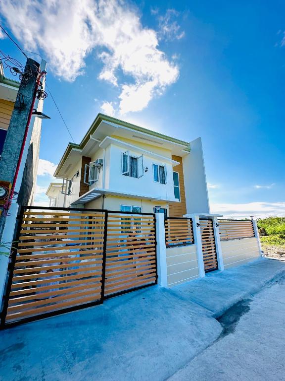 a house with a wooden fence in front of it at Casa VLOM Staycation in Roxas City
