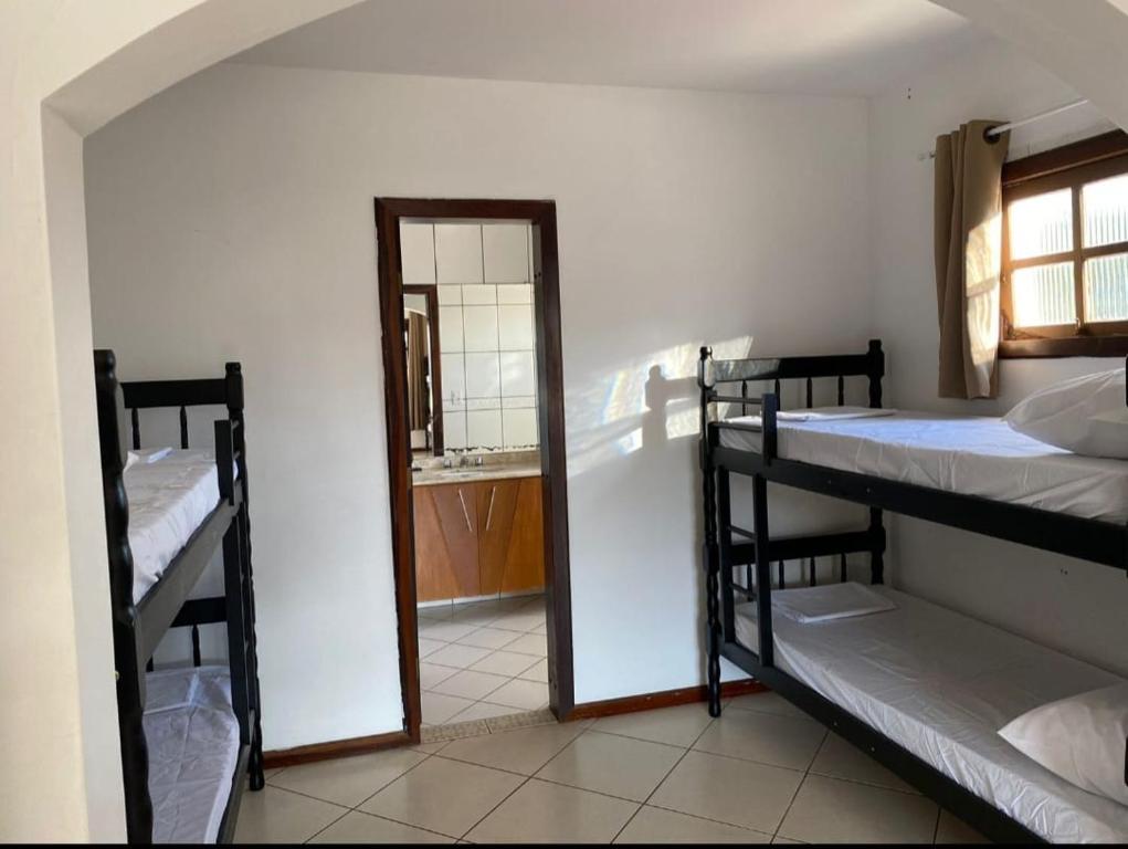 a room with two bunk beds and a mirror at Hostel da Dani in Balneário Camboriú