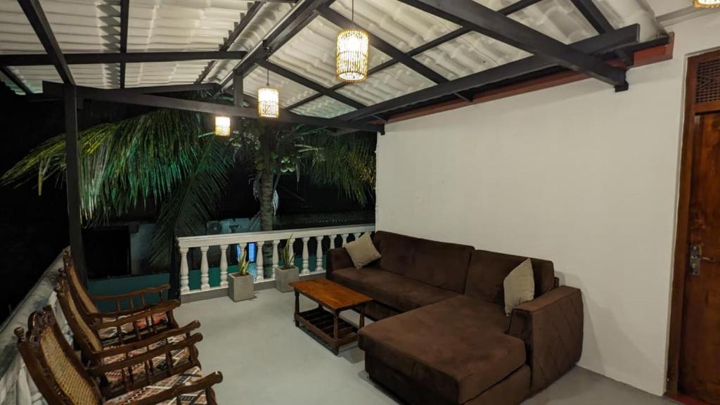 a living room with a couch and a table at MPR villa in Tangalle