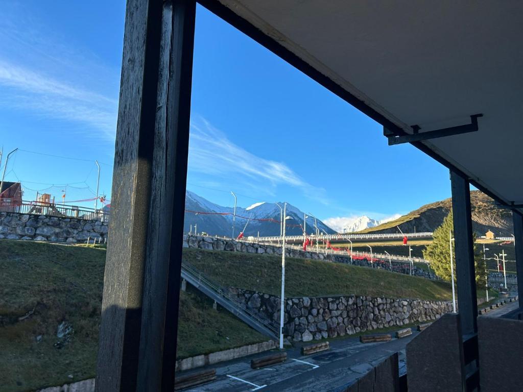 a view of a mountain through a window at appartement aux pieds des pistes in Cadeilhan-Trachère