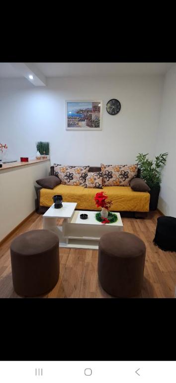 a living room with a couch and two stools at Mace MM :) in Šabac