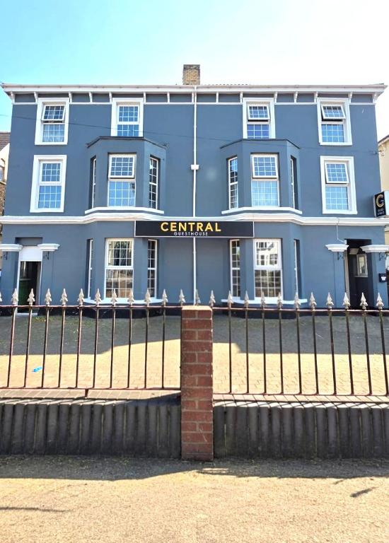 a blue building with a sign that reads central at Central Guest House in Newport