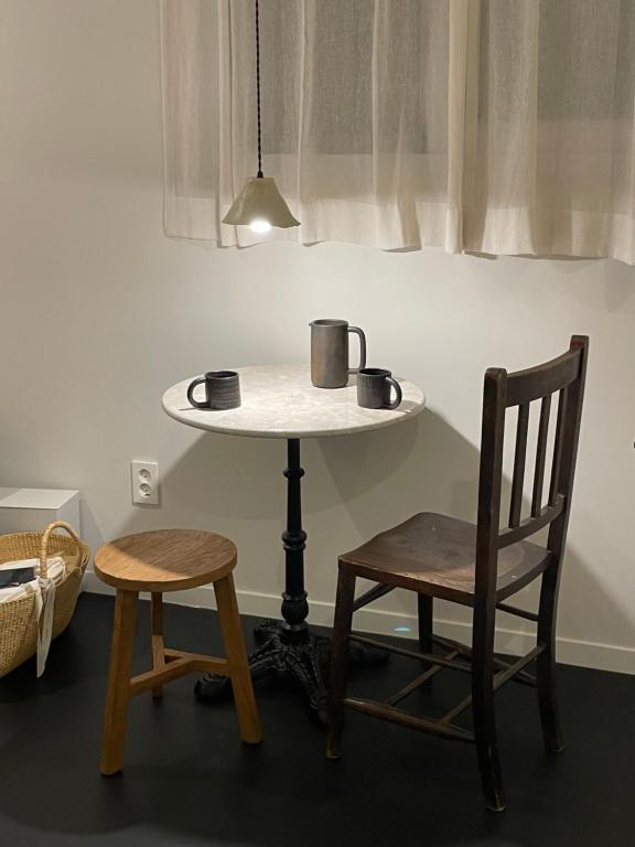 a table with two chairs and a table with two cups at stay early mansion 가산, 홍대, 고척돔 in Seoul