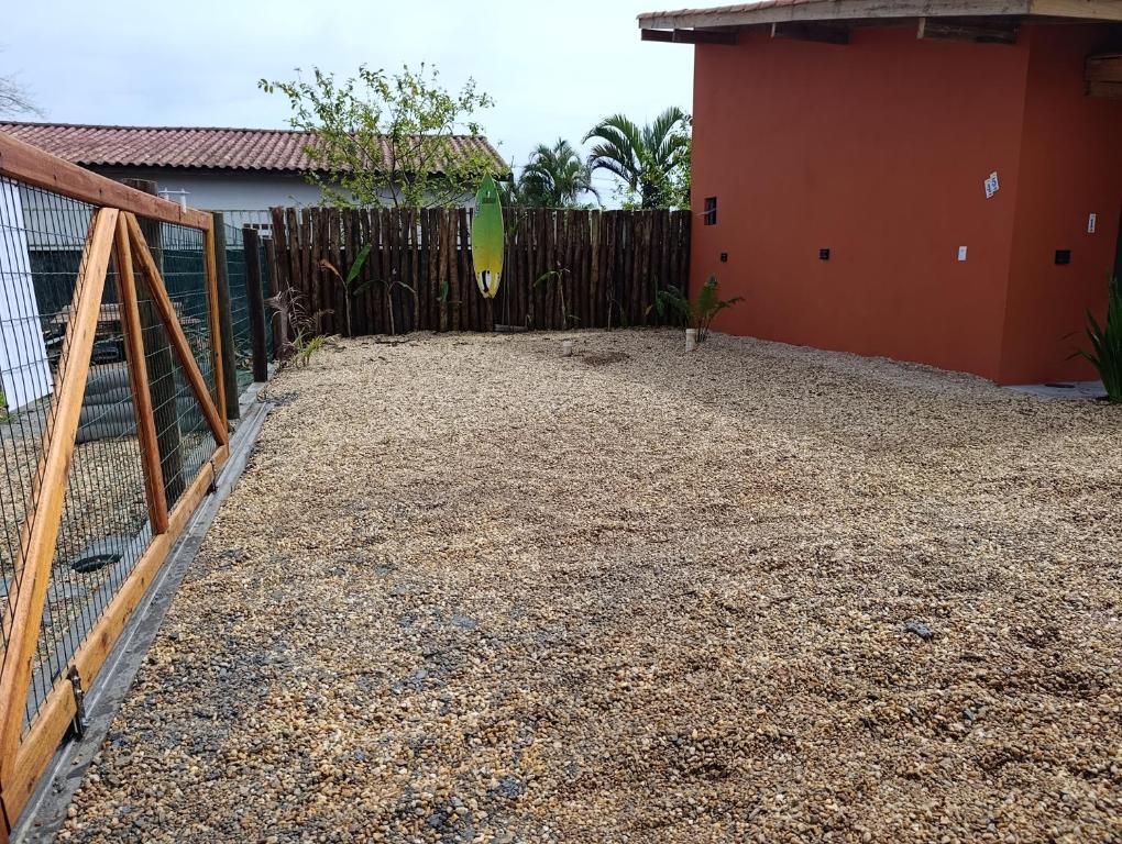 a fence in a yard next to a house at Vila Mar Lofts in Barra Velha