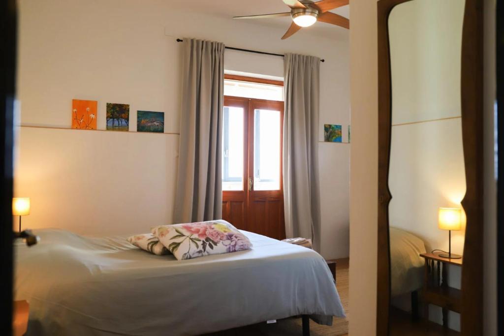 特雷斯努拉吉斯Anima Sarda Bed & Wine的一间卧室配有一张带窗户和枕头的床