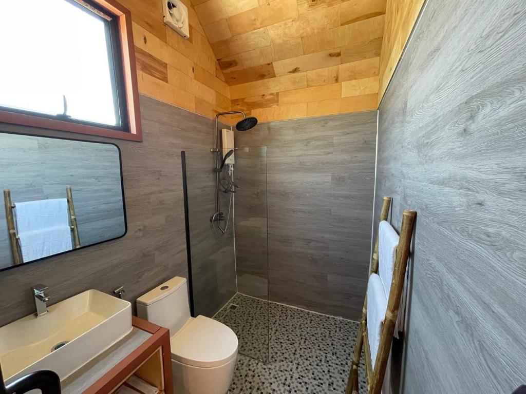 a bathroom with a toilet and a sink and a shower at Royal C Resort in Sihanoukville