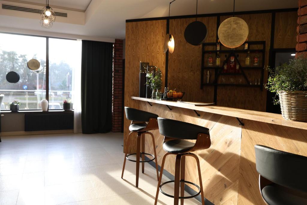 a bar with stools in a room with a window at Przystanek Słupno, 5 km od Płock in Słupno