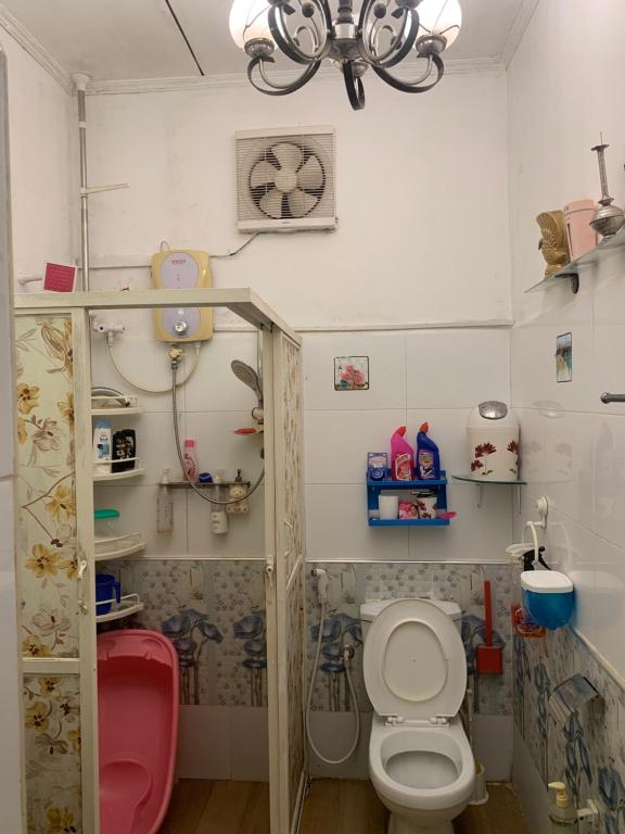 a small bathroom with a toilet and a chandelier at Rest Point 7 in Veyangoda