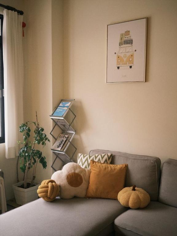 a stuffed animal sitting on a couch in a living room at Kaile Roaming Homestay in Magong