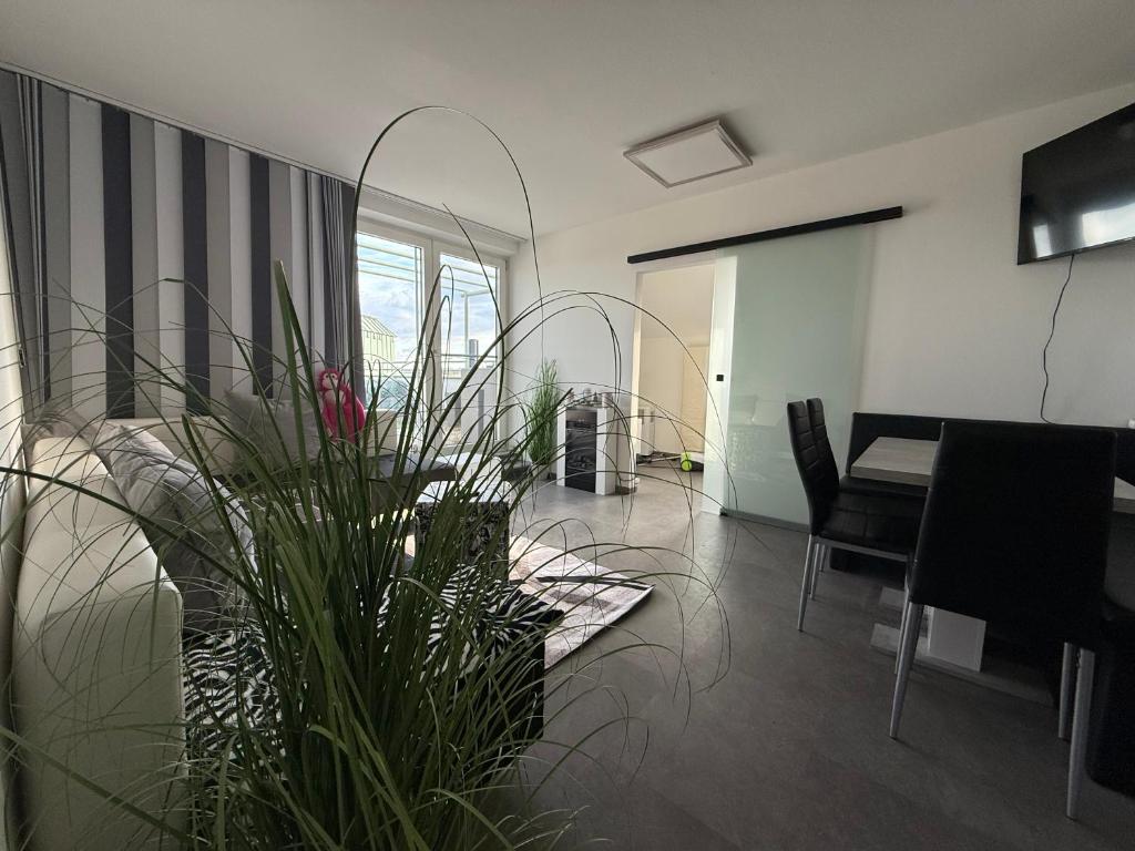 a living room with a table and a potted plant at City Dachterassen Traum in Vienna