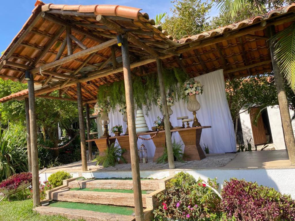 pergolato in legno con tavolo e alcuni fiori di Sítio Carmo a Ibirité