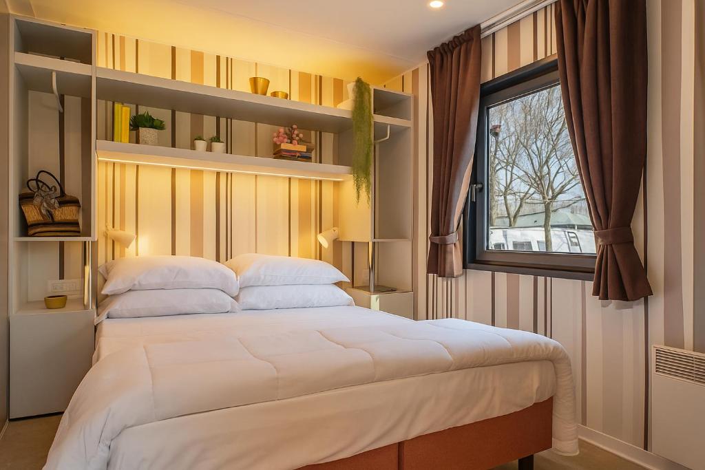 a bedroom with a large bed and a window at Hotiday Bologna Arena in Bologna