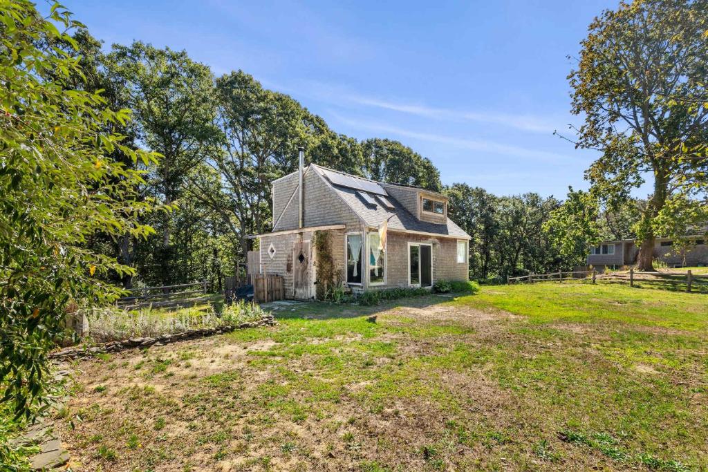 an old house in the middle of a field at Tranquil Cozy Cottage Recently Renovated in Wellfleet
