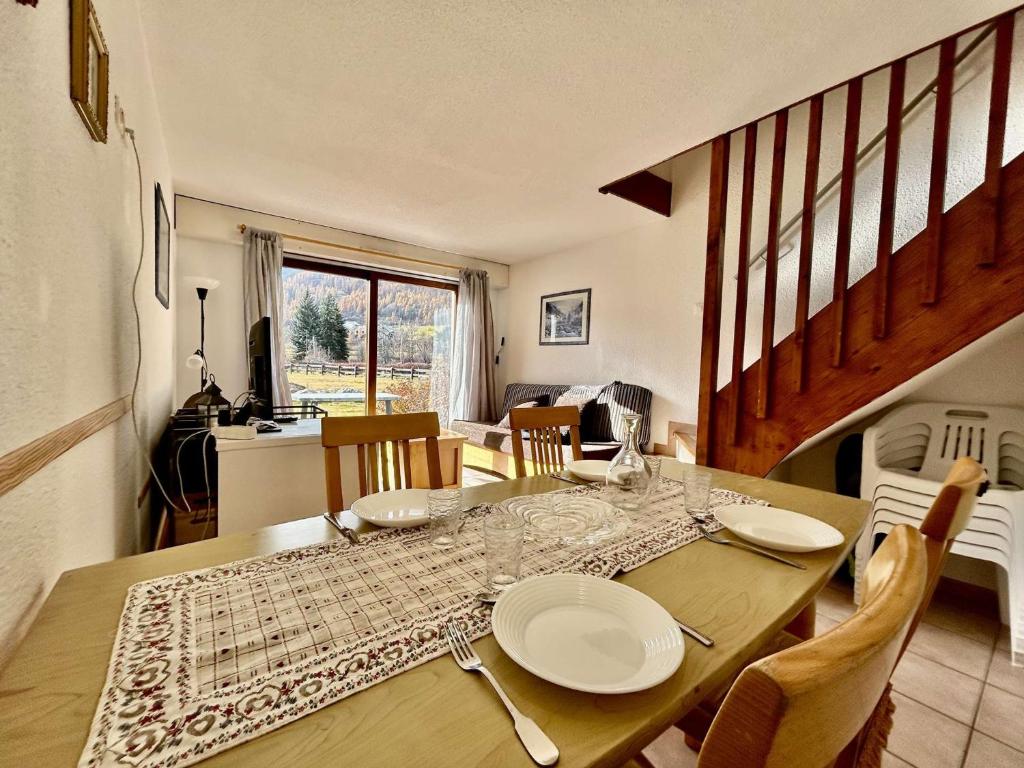 a dining room with a table with plates on it at Appartement cosy 3 pièces pour 6 pers. - Serre Chevalier - FR-1-330F-26 in Serre Chevalier
