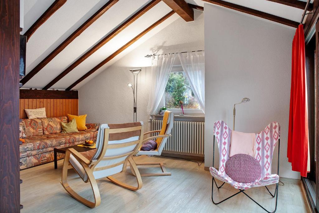 a living room with chairs and a couch at Haus Palais in Münstertal