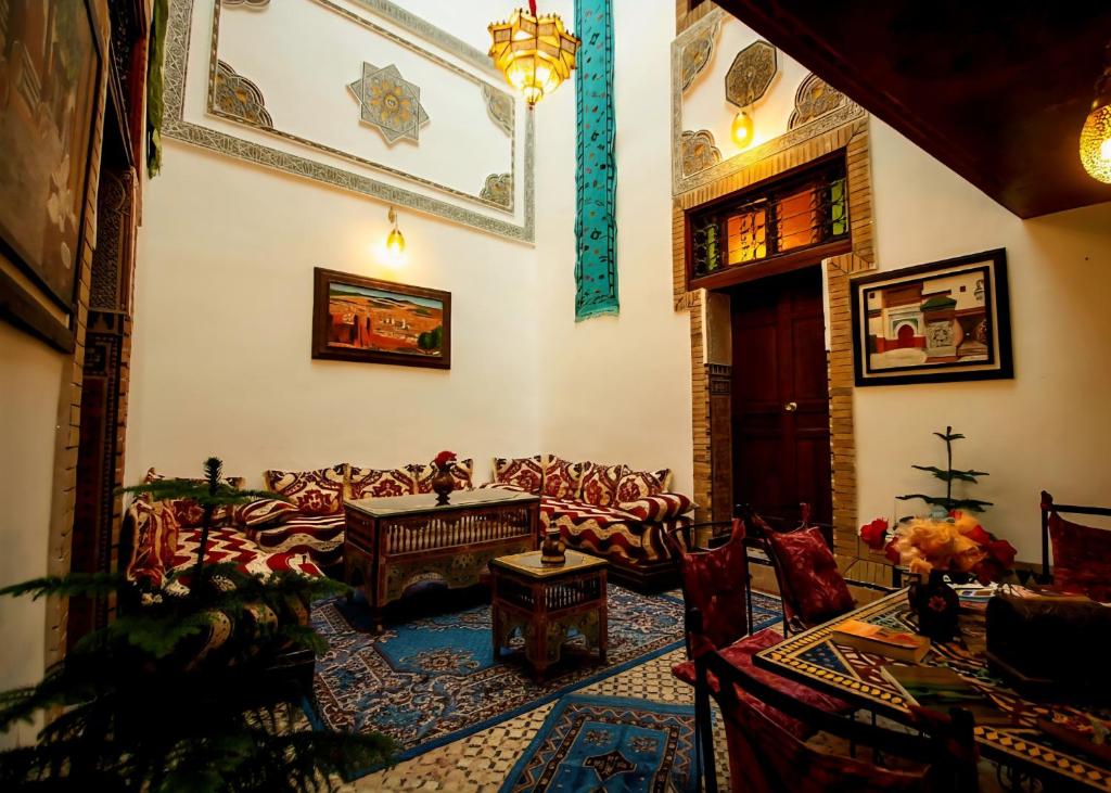 a living room with couches and a table at Riad BAB JDID in Fès