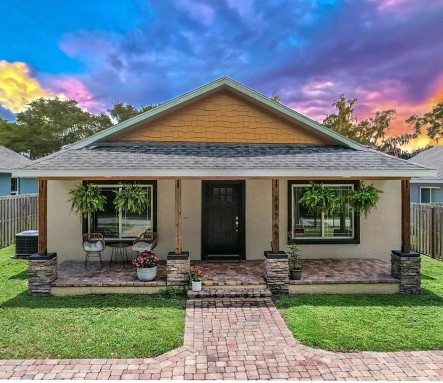 a small house with a patio in a yard at Rainbow River Bungalow with Early Checkin! in Dunnellon