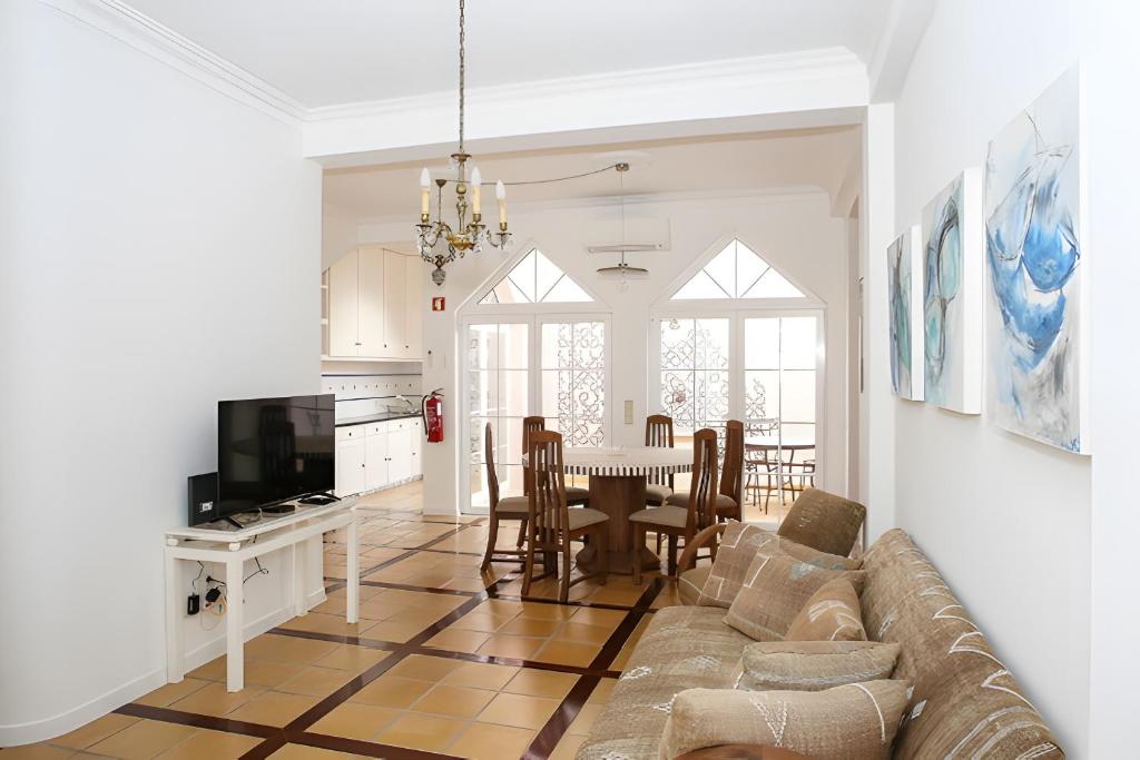 a living room with a couch and a table at Casa do Poço in Faro