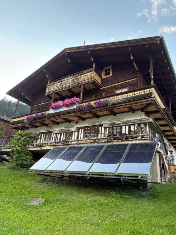 a house with a solar panel in front of it at Bergerbauer Krimml in Krimml