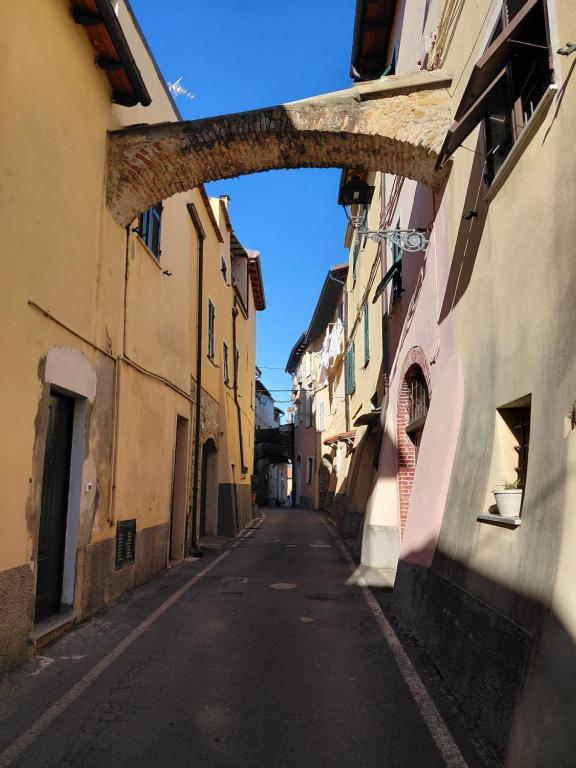 an empty street with an archway in a city at La Ginestra in Bastia
