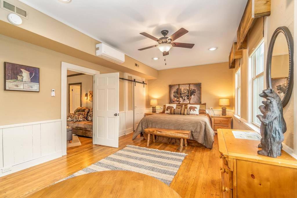 a bedroom with a bed and a ceiling fan at Cozy Cub Den in Bryson City