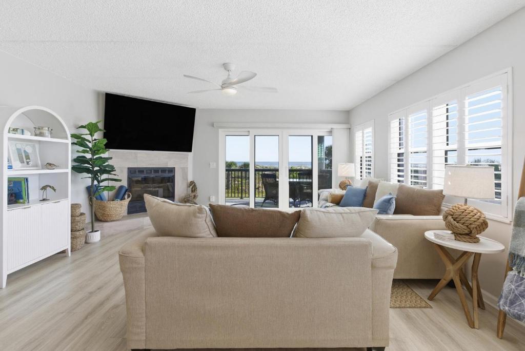 a living room with a couch and a tv at Bermuda Run 10 in Saint Augustine Beach