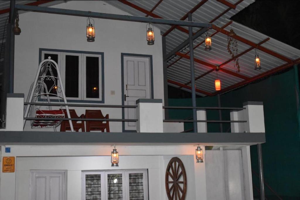 a house with a clock on the side of it at South point homestay in Virajpet