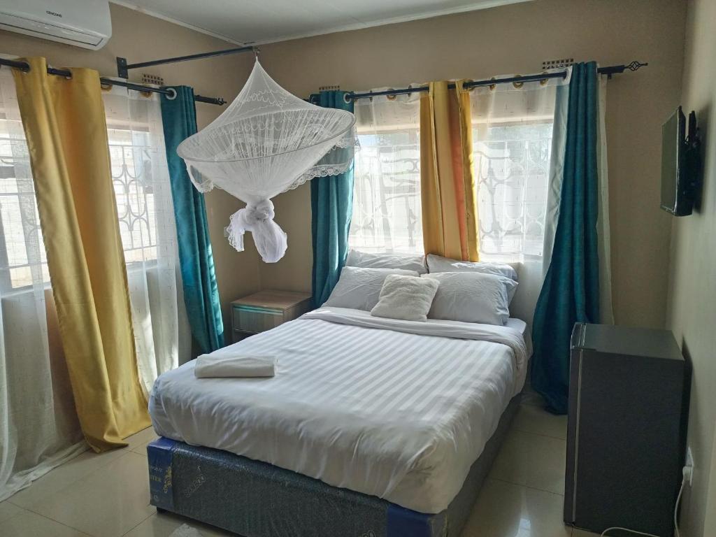 Ένα ή περισσότερα κρεβάτια σε δωμάτιο στο Savwa Lodges and Apartments