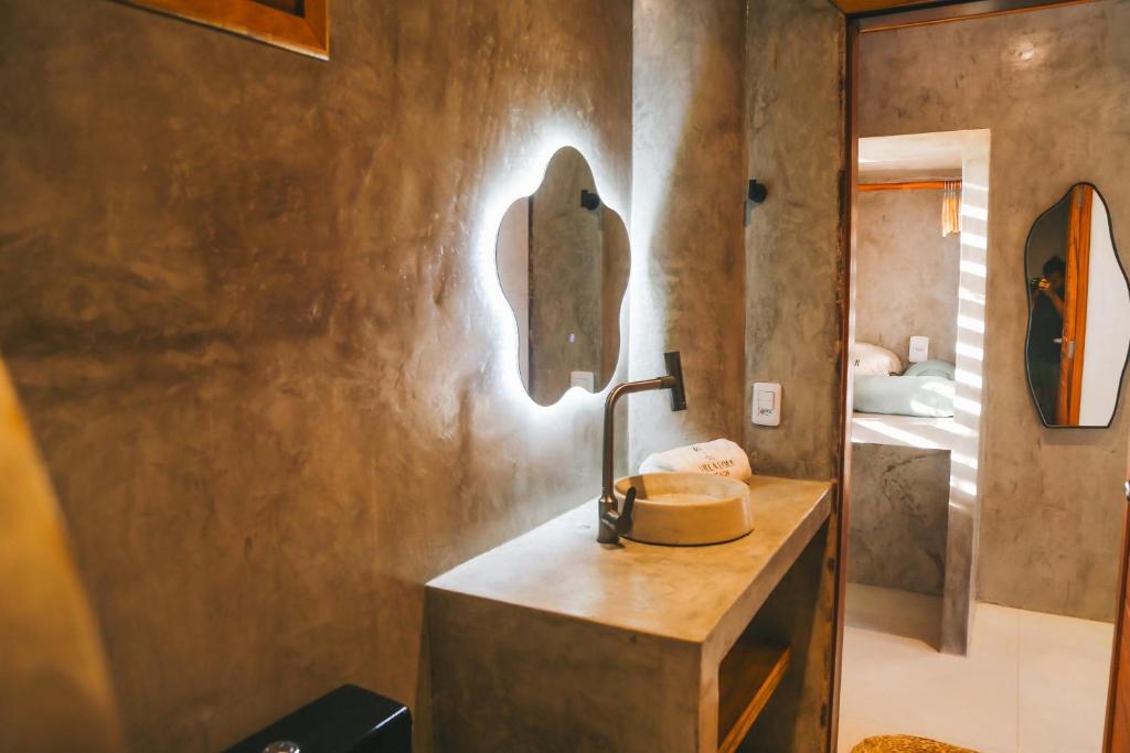 a bathroom with a sink and a mirror on the wall at Villa Loui Beach Icaraizinho-Ce in Icaraí