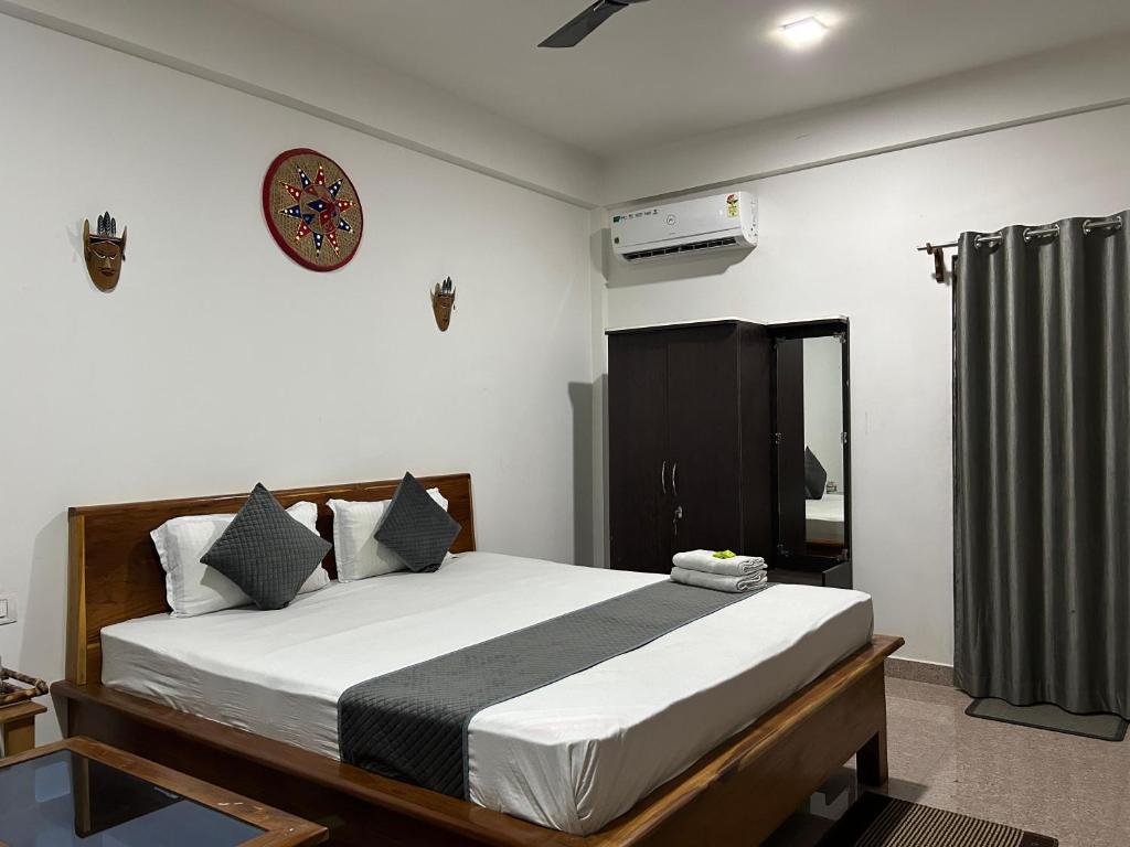 a bedroom with a bed and a clock on the wall at Lokosha Resort - The Green Destination in Hatikhuli