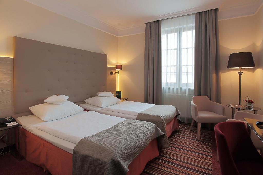 Postel nebo postele na pokoji v ubytování Hotel Branicki