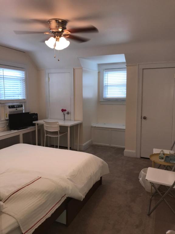 ein Schlafzimmer mit einem Bett und einem Deckenventilator in der Unterkunft 纽约 ZUHUA 长岛 Hofstra University霍夫斯特拉大学民宿 in Hempstead