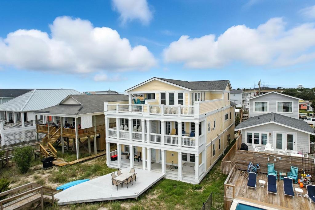 an aerial view of a large white house with a pool at After Dune Delight in Kure Beach