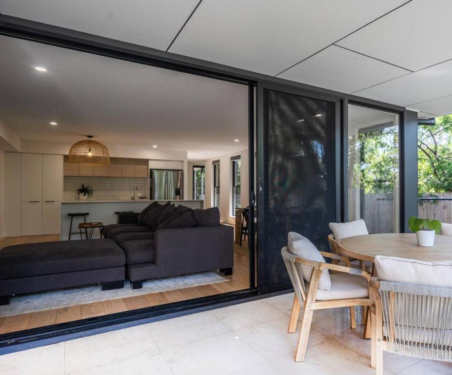 a living room with a couch and a table at Woodalla Way - Family Coastal Duplex Walk to Beach in Narrawallee