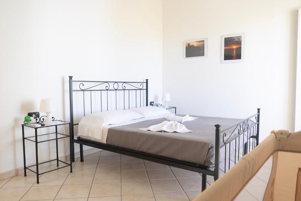 a bedroom with a metal bed in a white room at Al Primo Piano in Forio d'Ischia