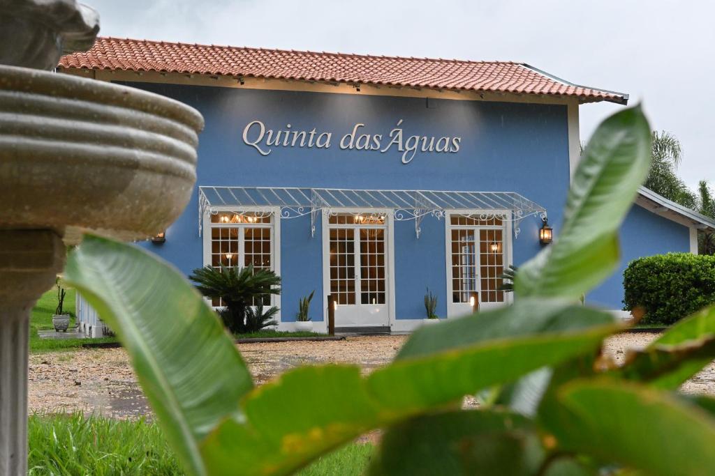 a blue building with a sign that reads authentic dog lounges at Quinta das Águas by Summit Hotels in Itapira