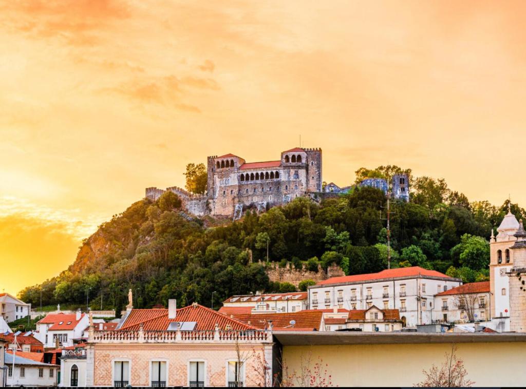 a castle on top of a hill with buildings at Pedrogão Soul & Sunset in Pedrógão