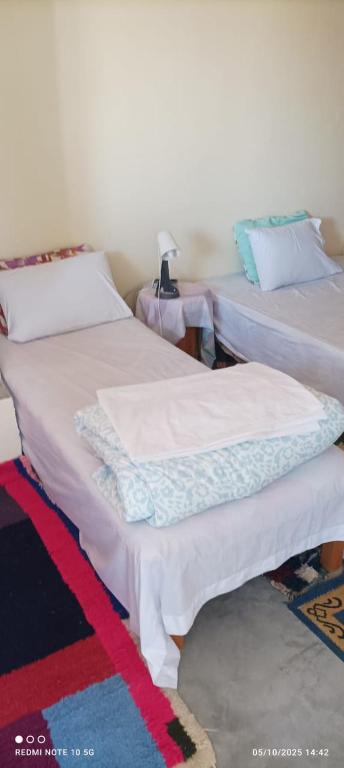 two beds sitting next to each other in a room at Refuge AIT M'HAMED in Aït Mehammed