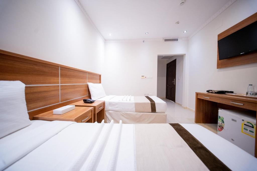 Ένα ή περισσότερα κρεβάτια σε δωμάτιο στο Orvana Al Otaibiya Hotel