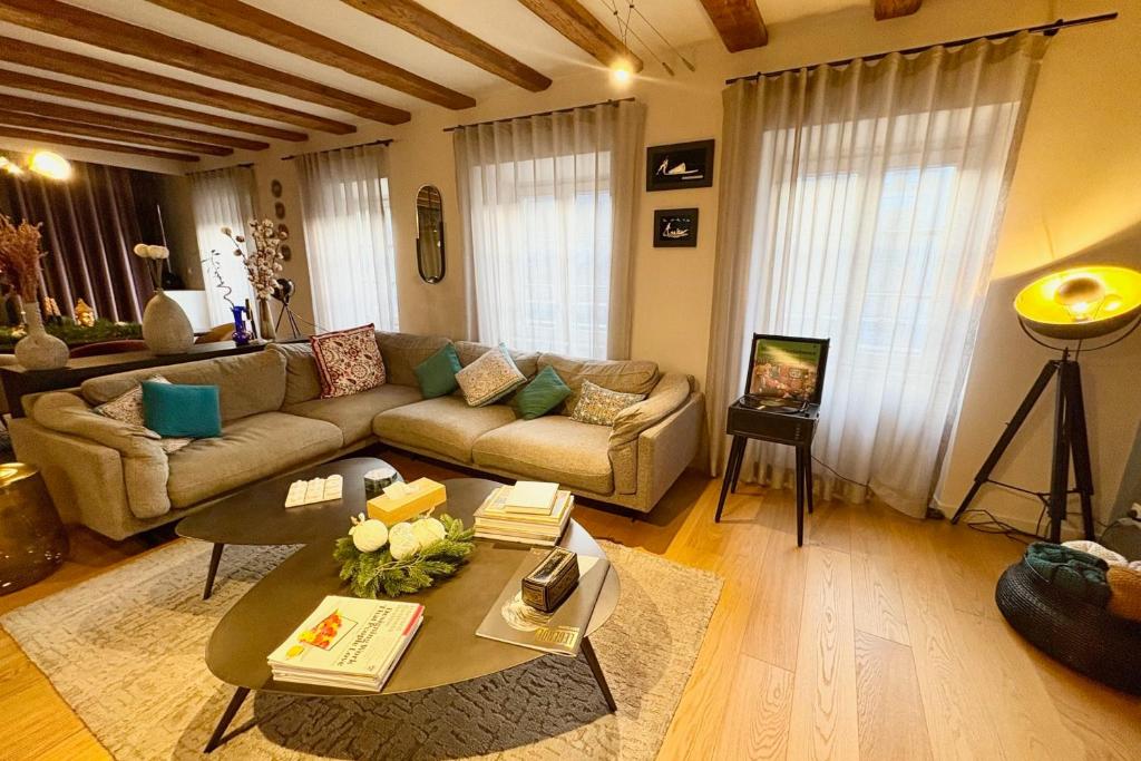 a living room with a couch and a table at Luxury apartment in the city center in Strasbourg