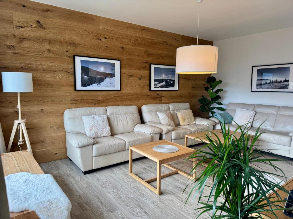 a living room with a couch and a table at Family Apartment 104 in Špindlerův Mlýn