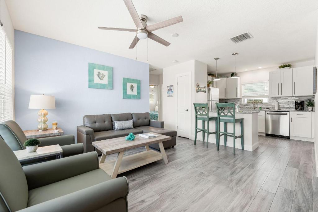a living room with a couch and a table at Sun and Sea By Beachside Management in Siesta Key