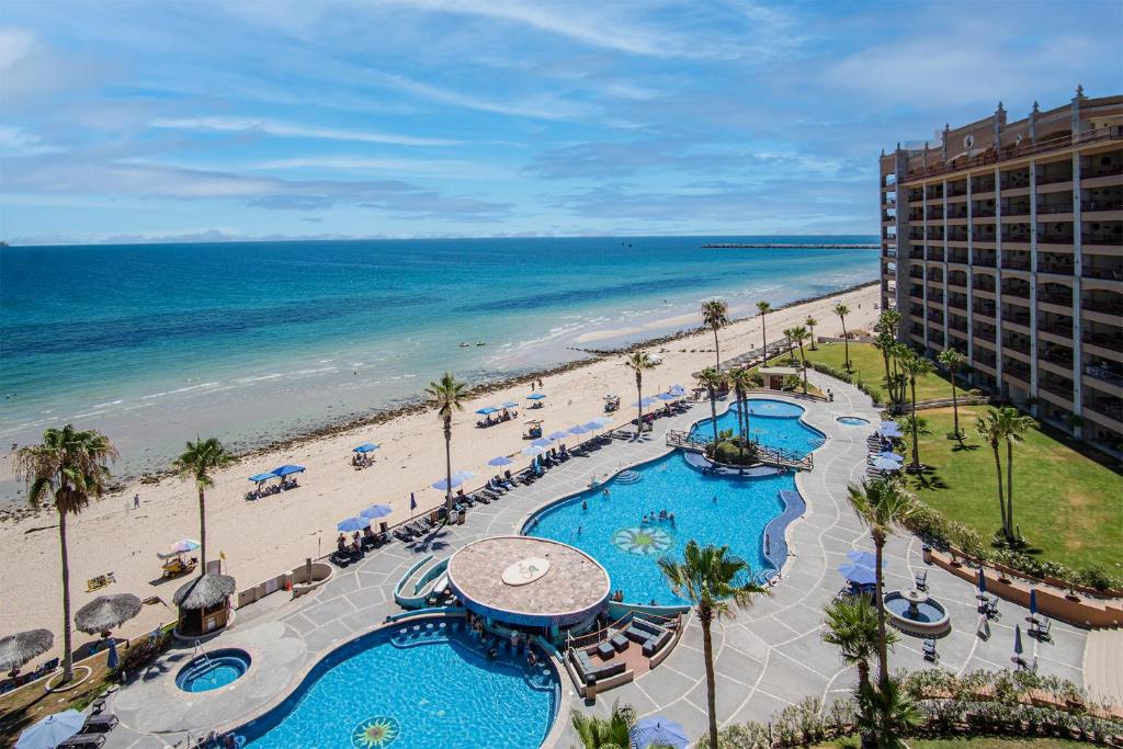 an aerial view of a beach with a hotel and the ocean at Happy-N-The-Sun 2 BR Oceanfront in Puerto Peñasco