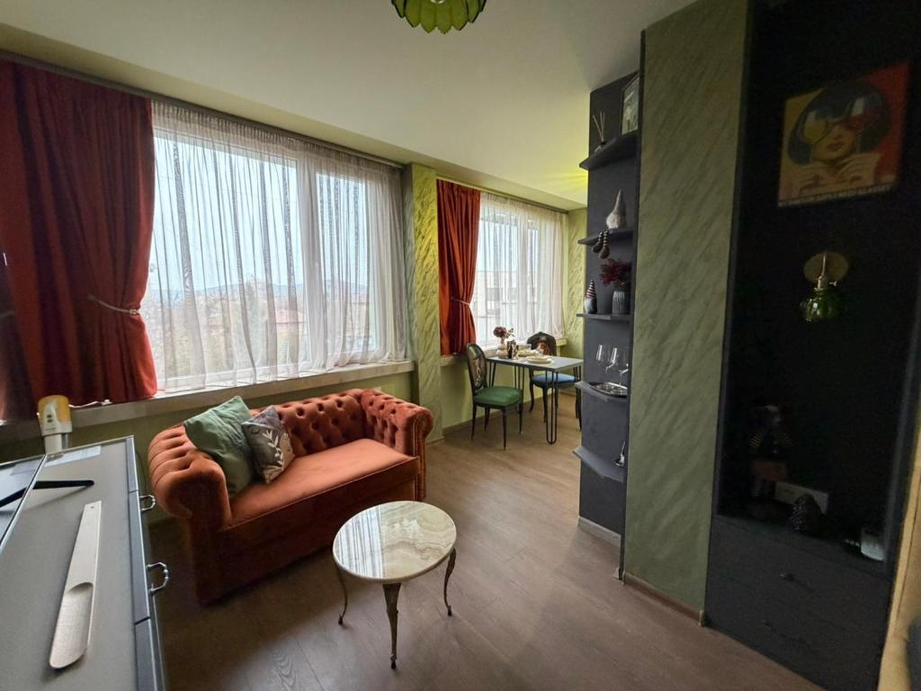 a living room with a couch and a table at Yantra Tower Deluxe in Gabrovo