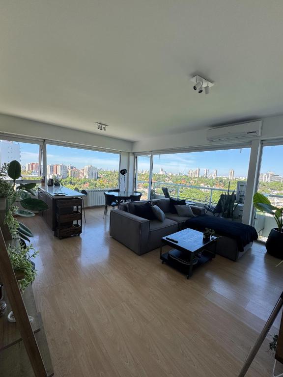 a living room with couches and a view of the city at 2 ambientes con Amenities y Vista al Río in Vicente López