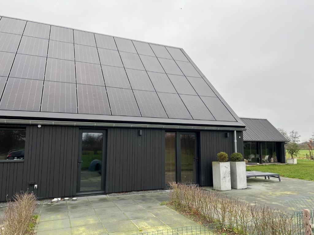 a building with a lot of solar panels on it at B&B Smalle Ee Kleasterpleats 