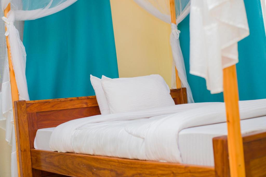 Postel nebo postele na pokoji v ubytování Bamboo Savanna Villas